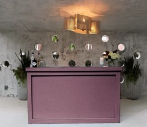 Mauve-colored bar structure ready for drinks service.